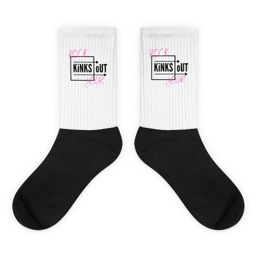 R.Y.K.O. pink and black logo socks with black cushioned bottom and white ribbed leg portion. Crew length.